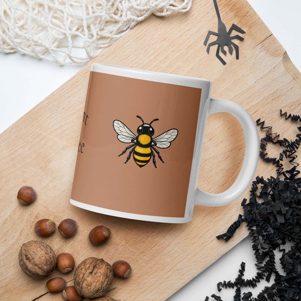 Brown ceramic coffee mug with bee illustration and white handle