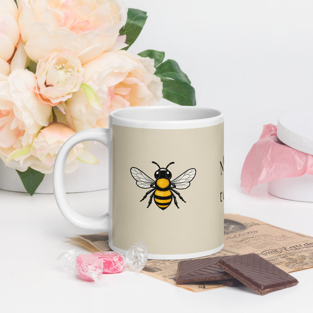 Light beige ceramic mug with large bee illustration on front