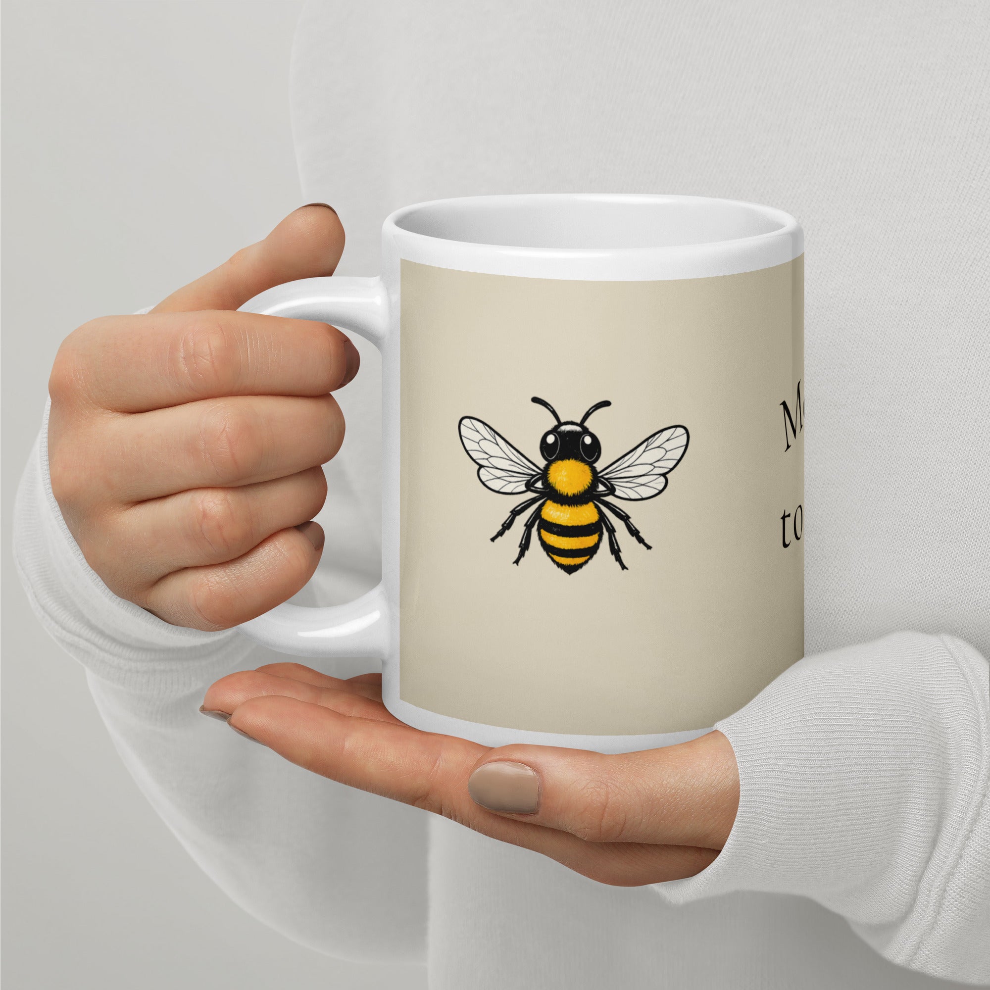 Light beige ceramic mug with bee illustration and “Meant to Bee” text on side