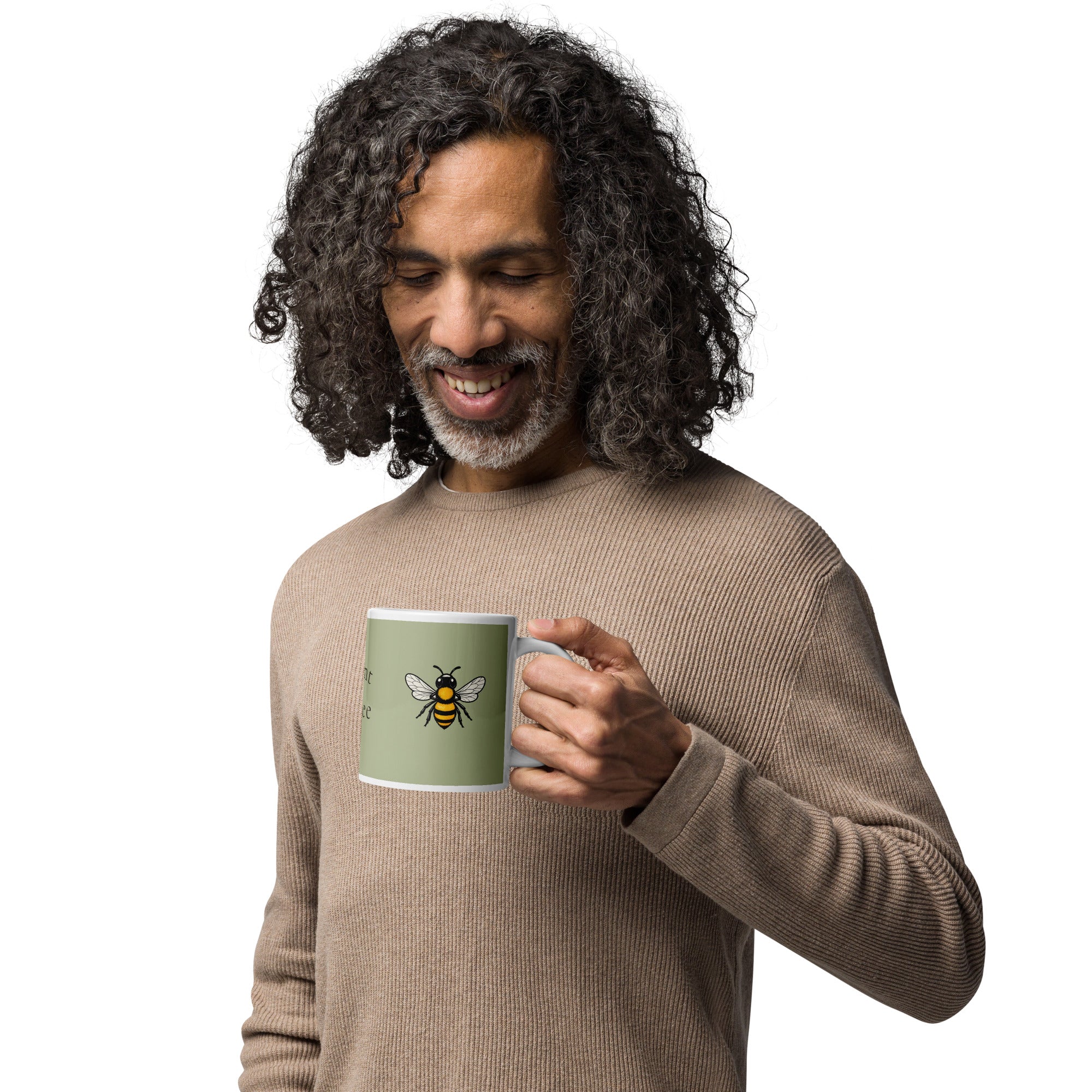 Sage green ceramic coffee mug with bee illustration, held near chin