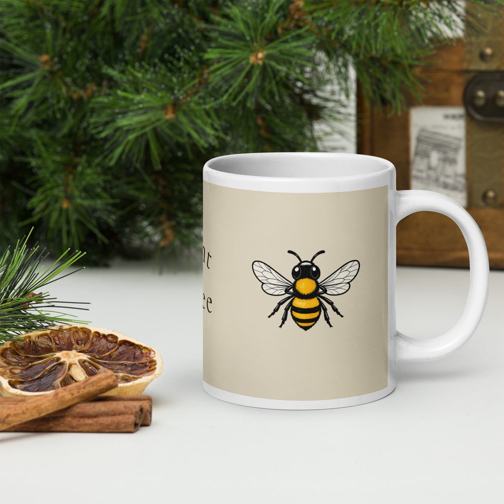Light beige ceramic coffee mug with white handle and bee illustration near center