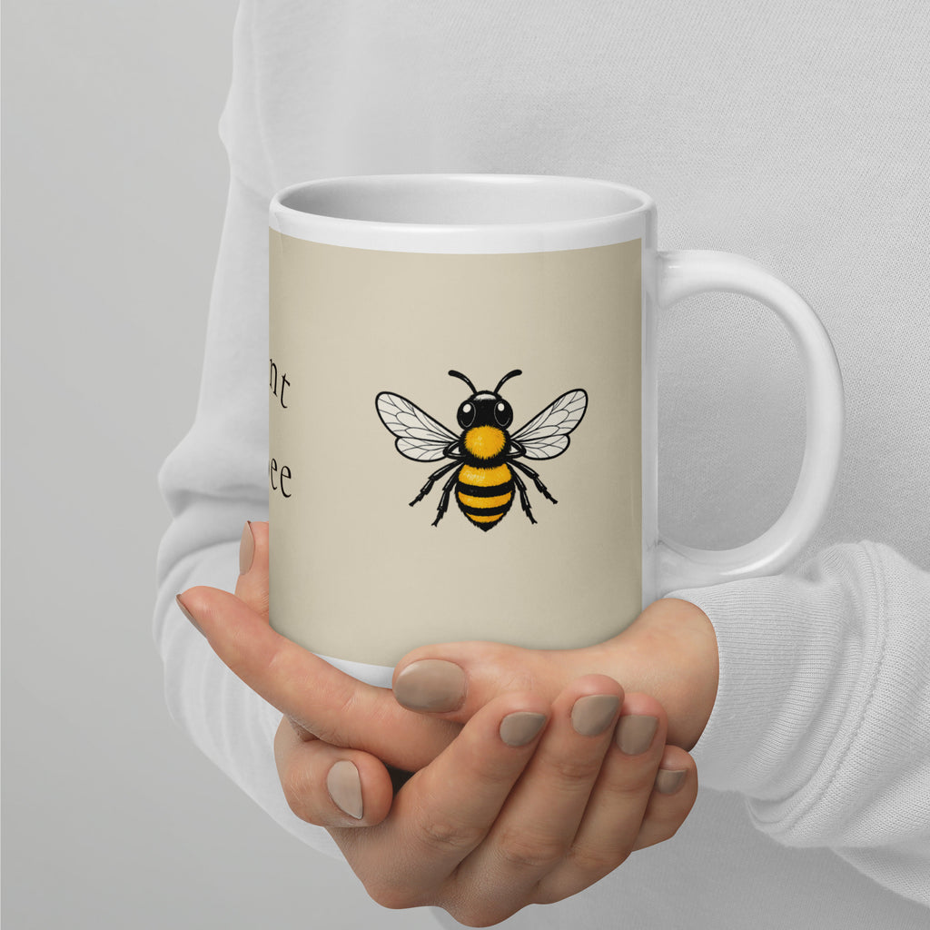 Light beige ceramic coffee mug with black and yellow bee illustration on side