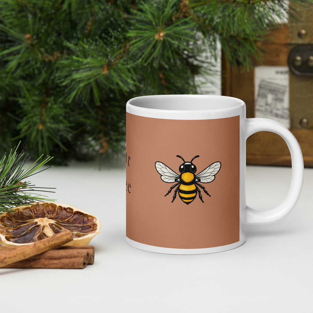 Brown ceramic coffee mug with centered bee illustration and white handle