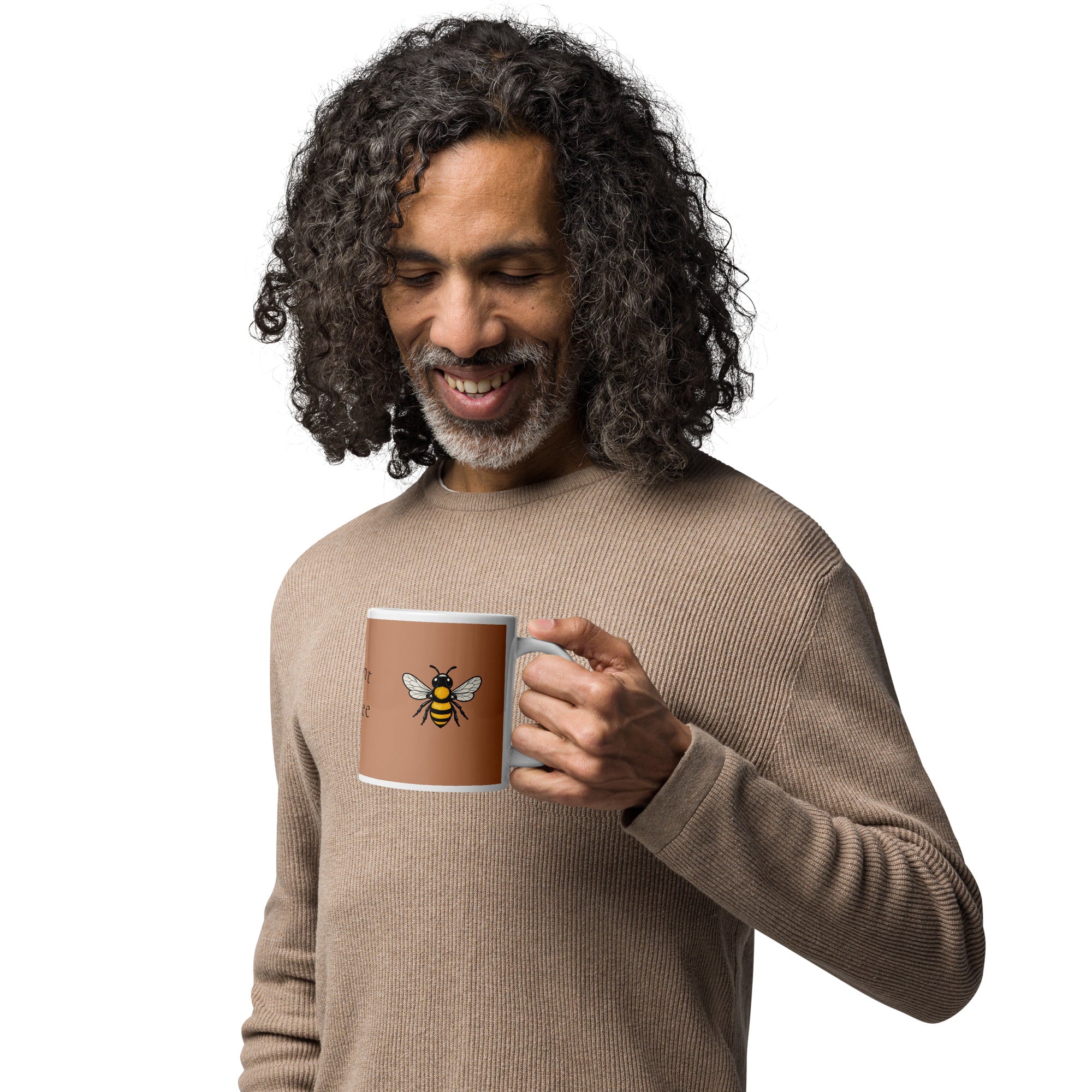 Brown ceramic mug with white rim and handle, bee illustration shown in hand
