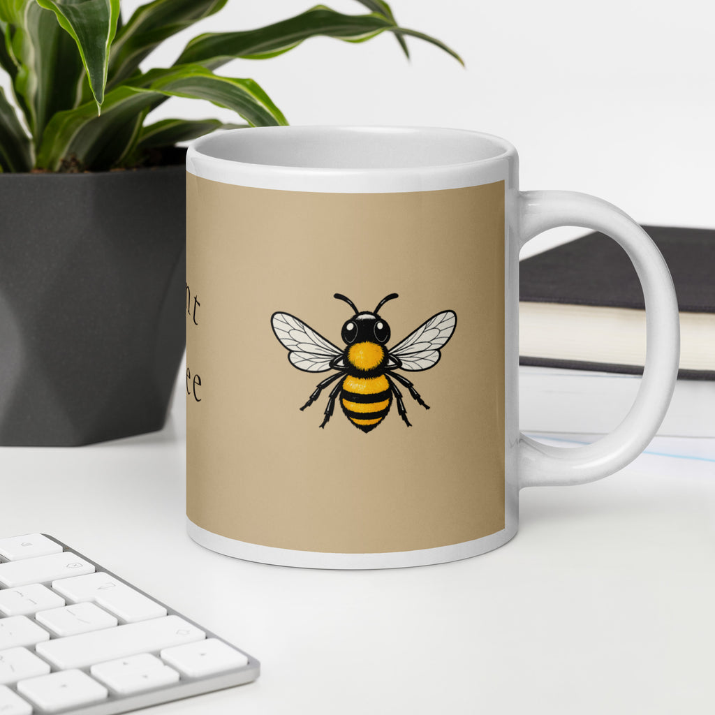 Beige ceramic mug with bee illustration on front and white base