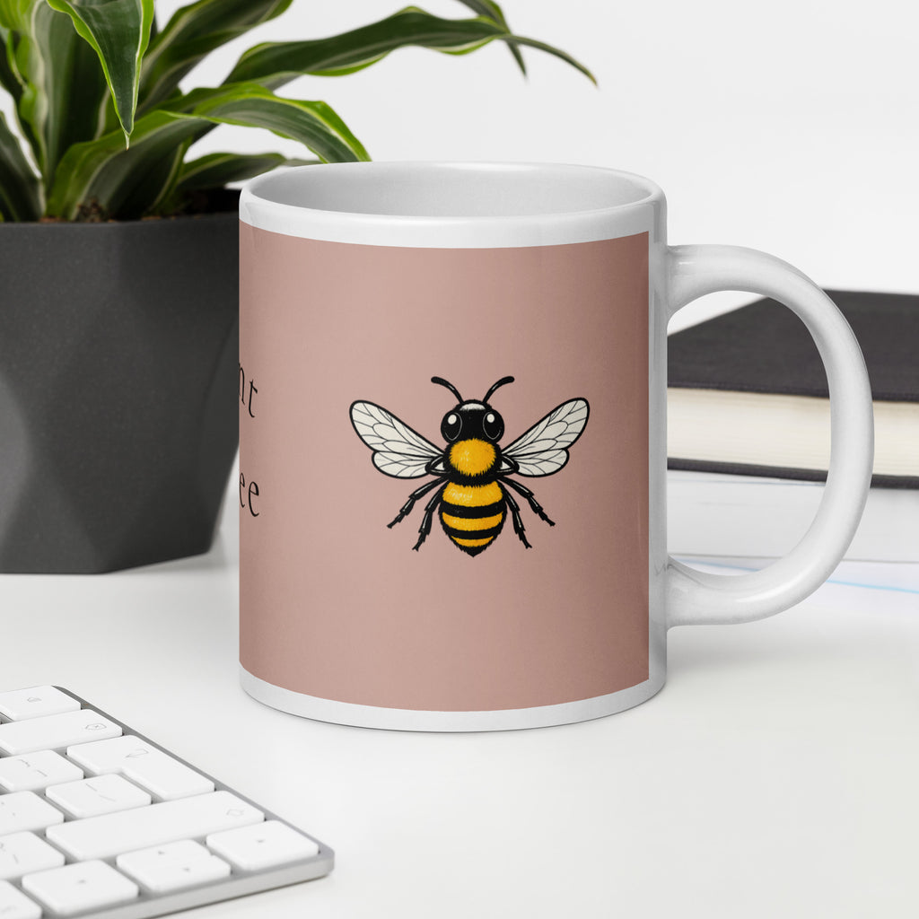 Dusty rose ceramic coffee mug with white handle and rim, black-yellow bee graphic