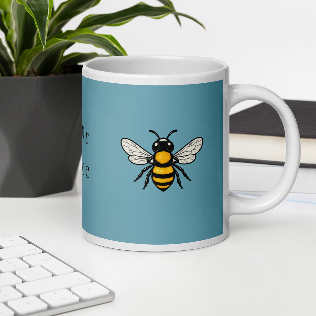 Blue ceramic mug with bee illustration, partial text on side, white rim